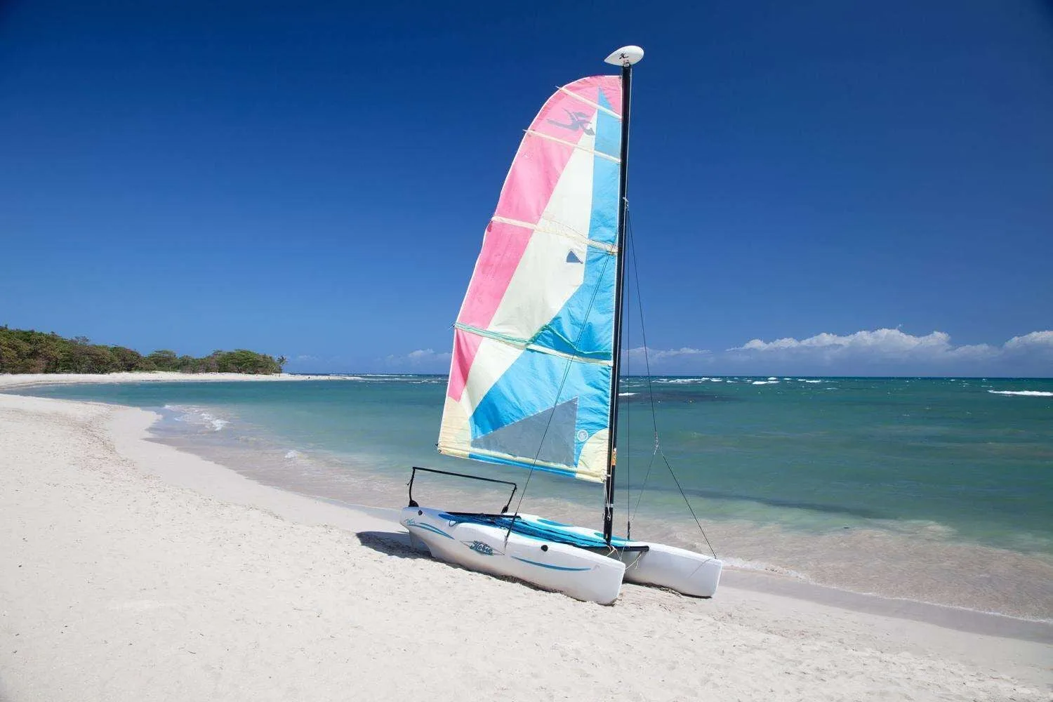 Catamaran on the white-sand beach at Iberostar Waves Costa Dorada.