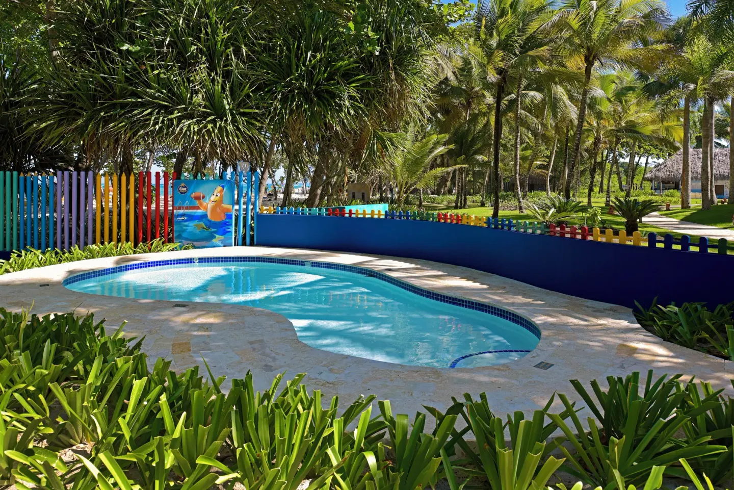 Small children’s pool with colorful fence at Iberostar Waves Costa Dorada.