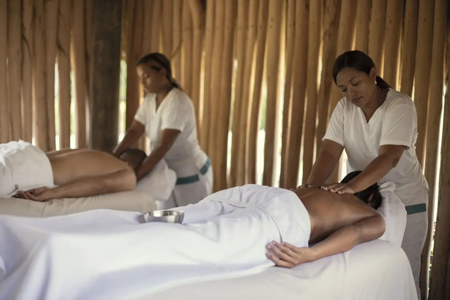 Two guests receiving massages in a spa cabana at Iberostar Waves Costa Dorada.