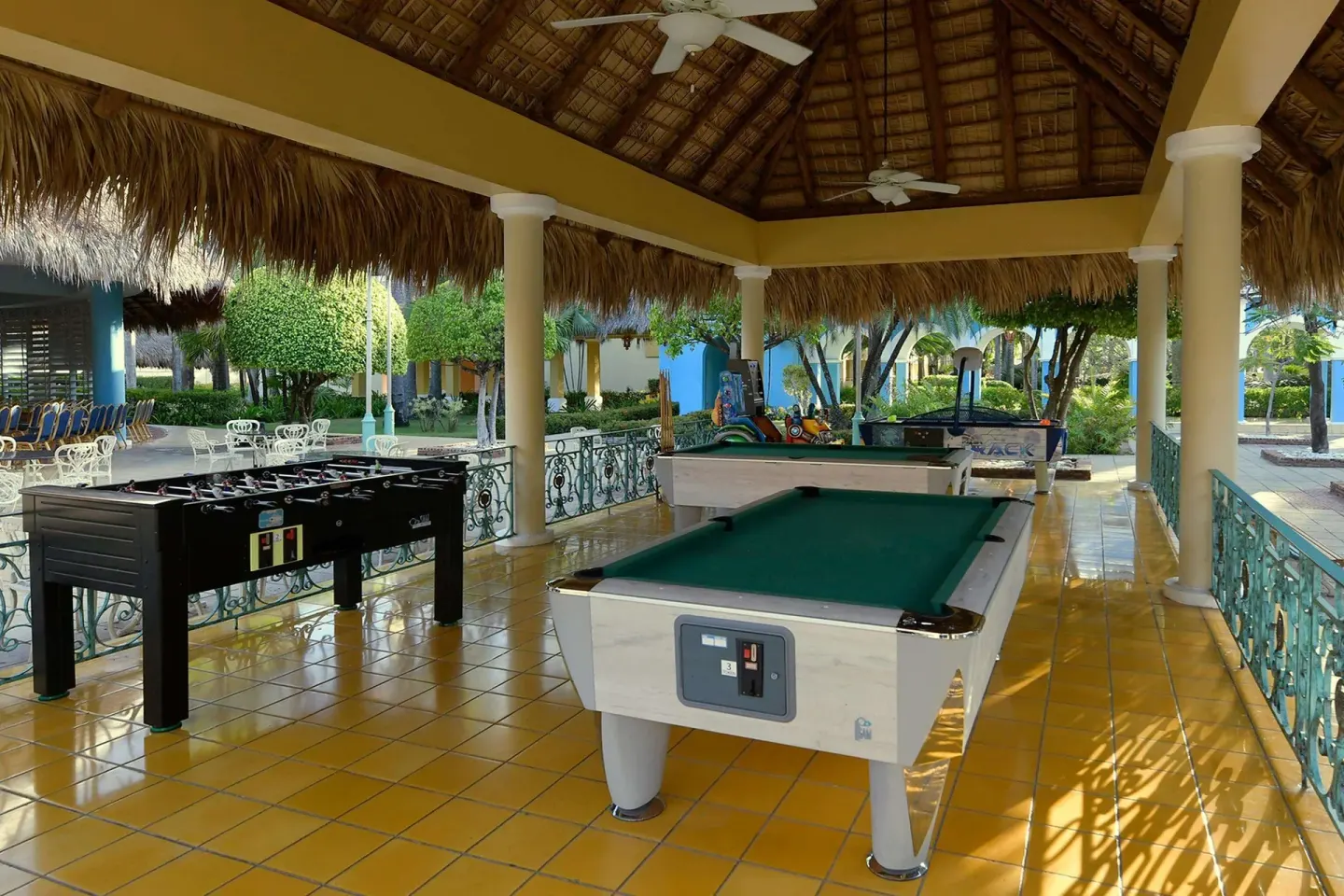Covered games terrace with billiards and foosball at Iberostar Waves Costa Dorada.