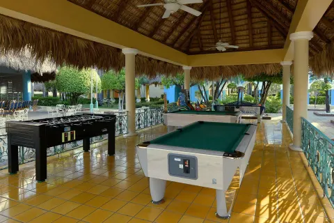 Covered games terrace with billiards and foosball at Iberostar Waves Costa Dorada.