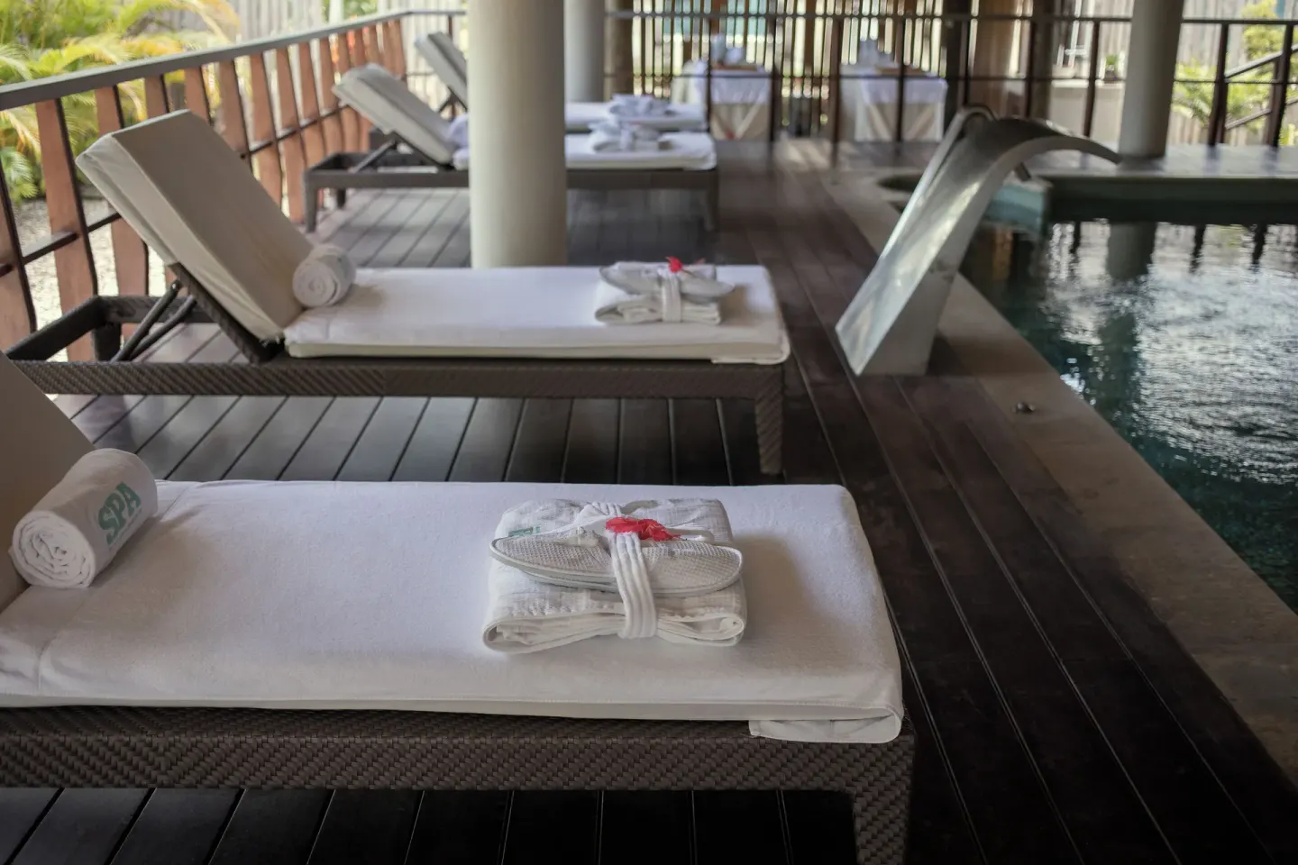 Spa loungers beside an indoor hydrotherapy pool at Iberostar Waves Costa Dorada.