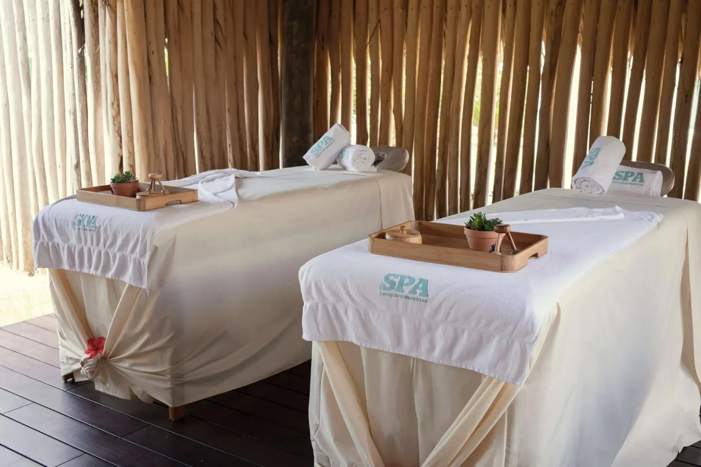 Two prepared spa treatment beds in a cabana at Iberostar Waves Costa Dorada.
