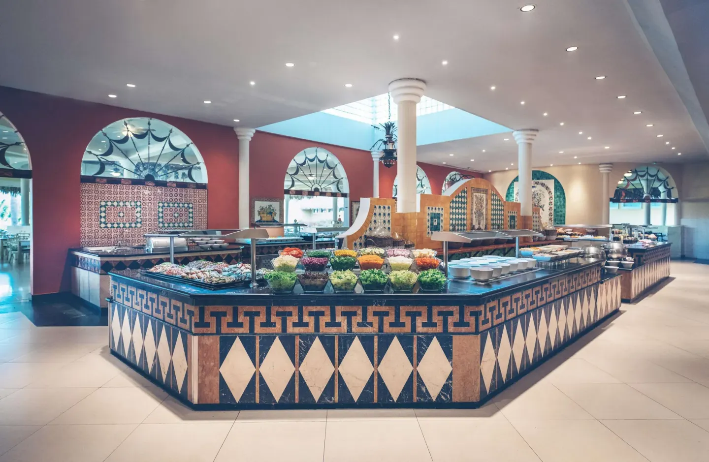 Buffet counter with salads and tiled decor at Iberostar Waves Costa Dorada.