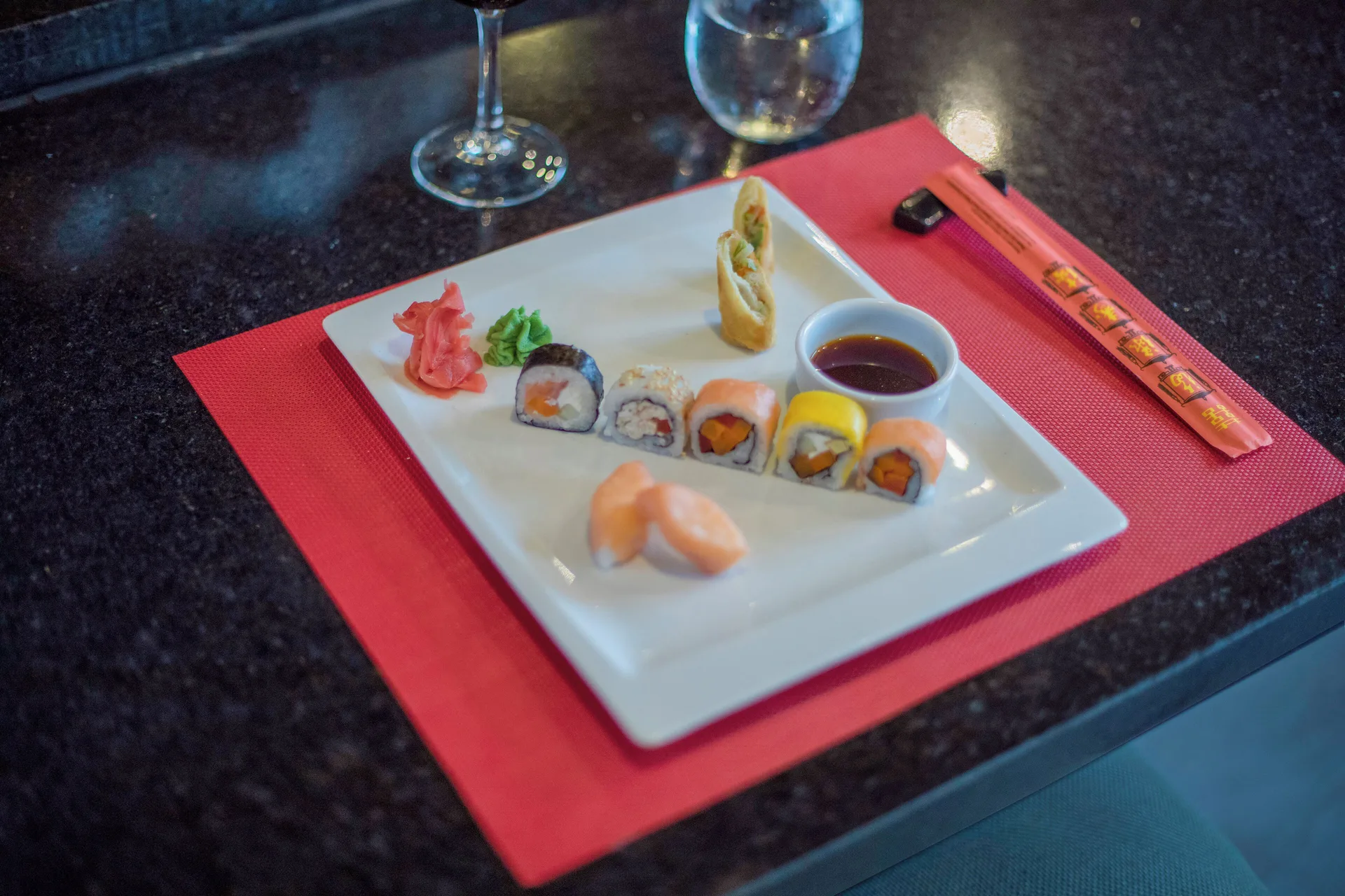 Sushi plate with chopsticks and dipping sauce at Iberostar Waves Costa Dorada.