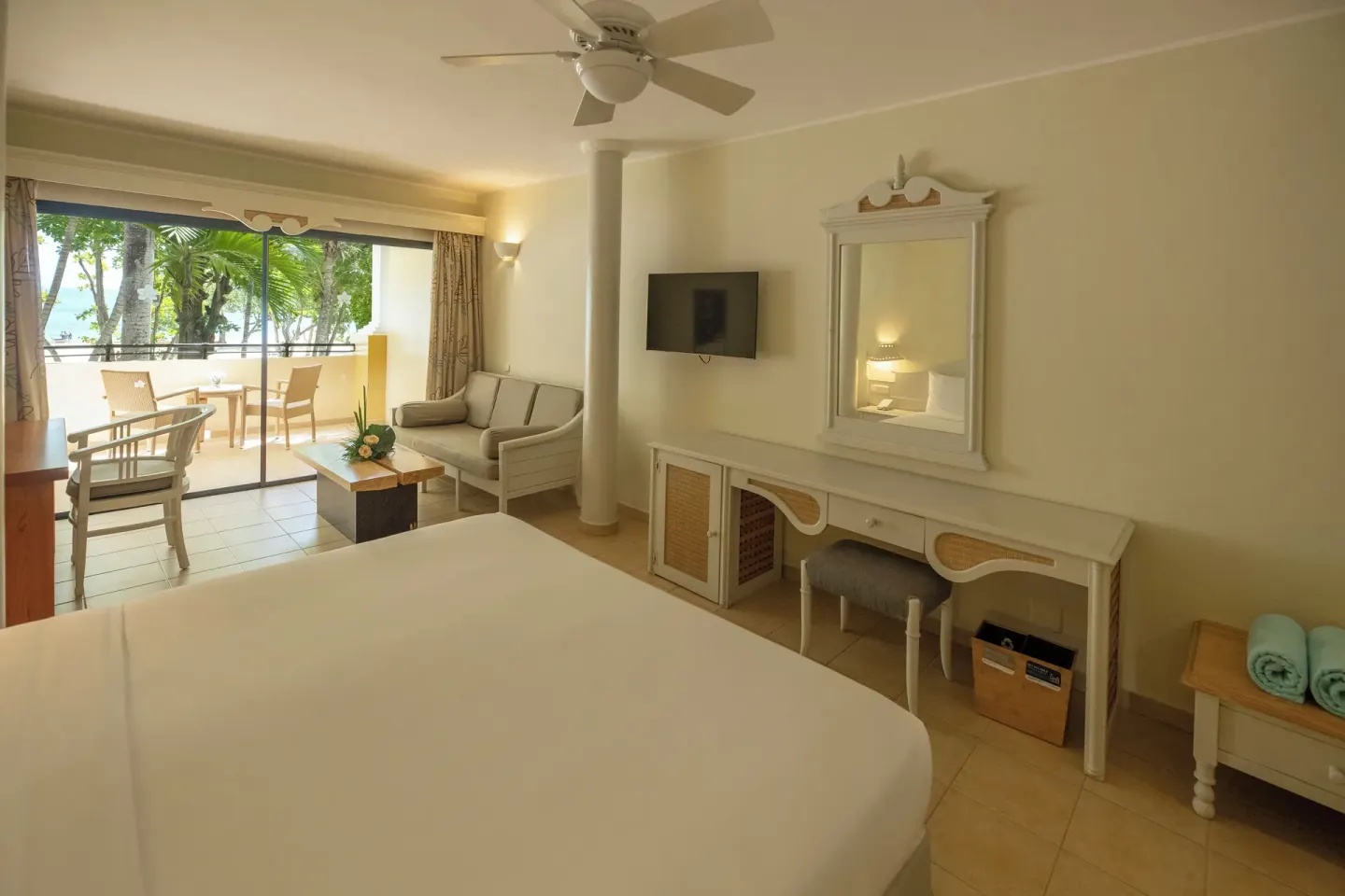 Junior Suite Oceanfront king bed and balcony at Iberostar Waves Costa Dorada.
