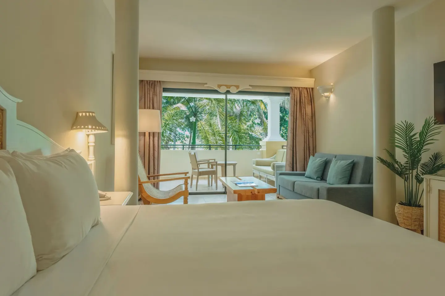 Junior Suite Oceanfront king bed and lounge at Iberostar Waves Costa Dorada.