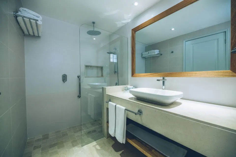 Premium Room Ocean View bathroom with shower and vanity at Iberostar Waves Costa Dorada.