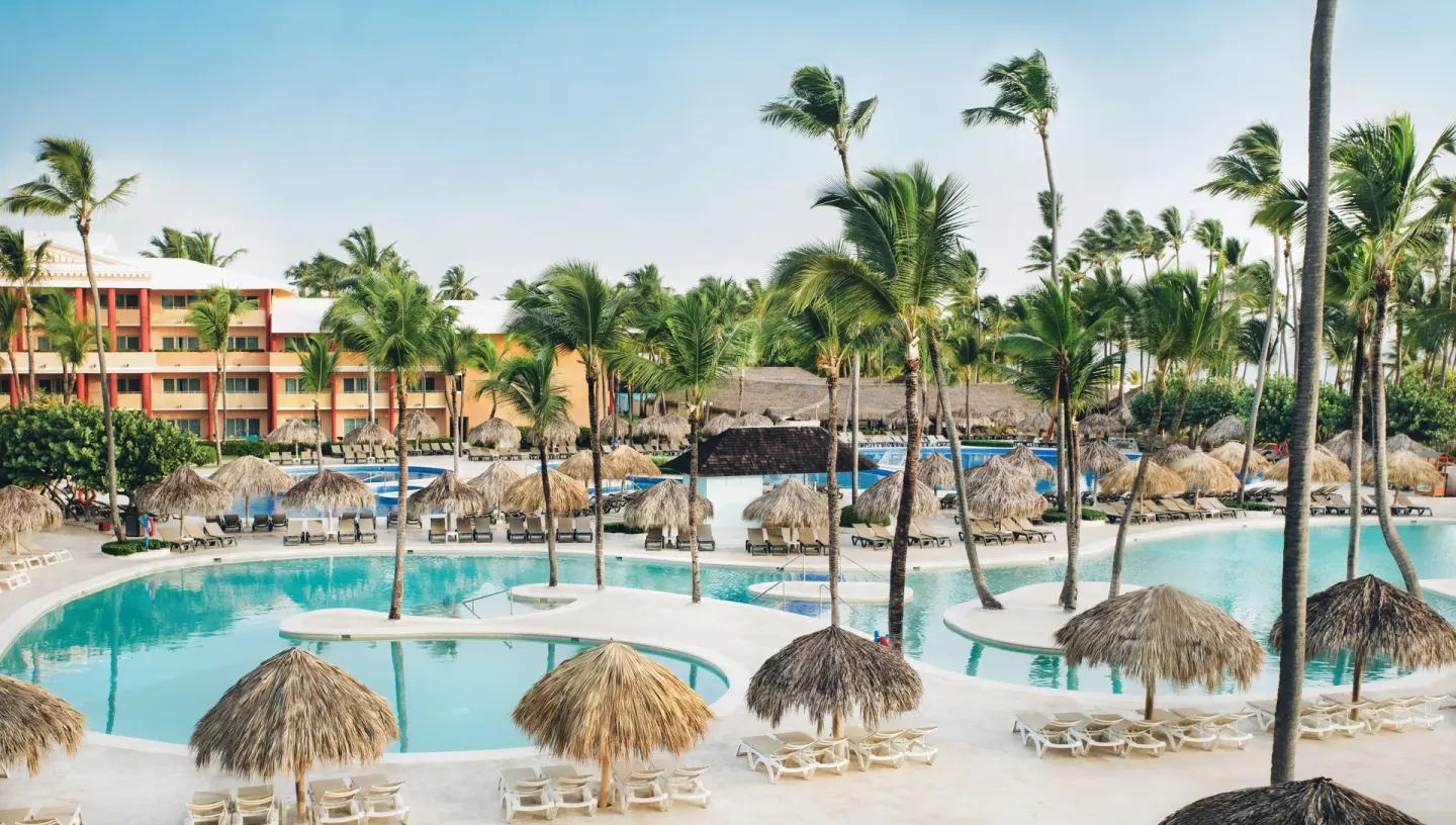 Elevated view of pools, palapas, palms, and resort buildings at Iberostar Waves Dominicana.