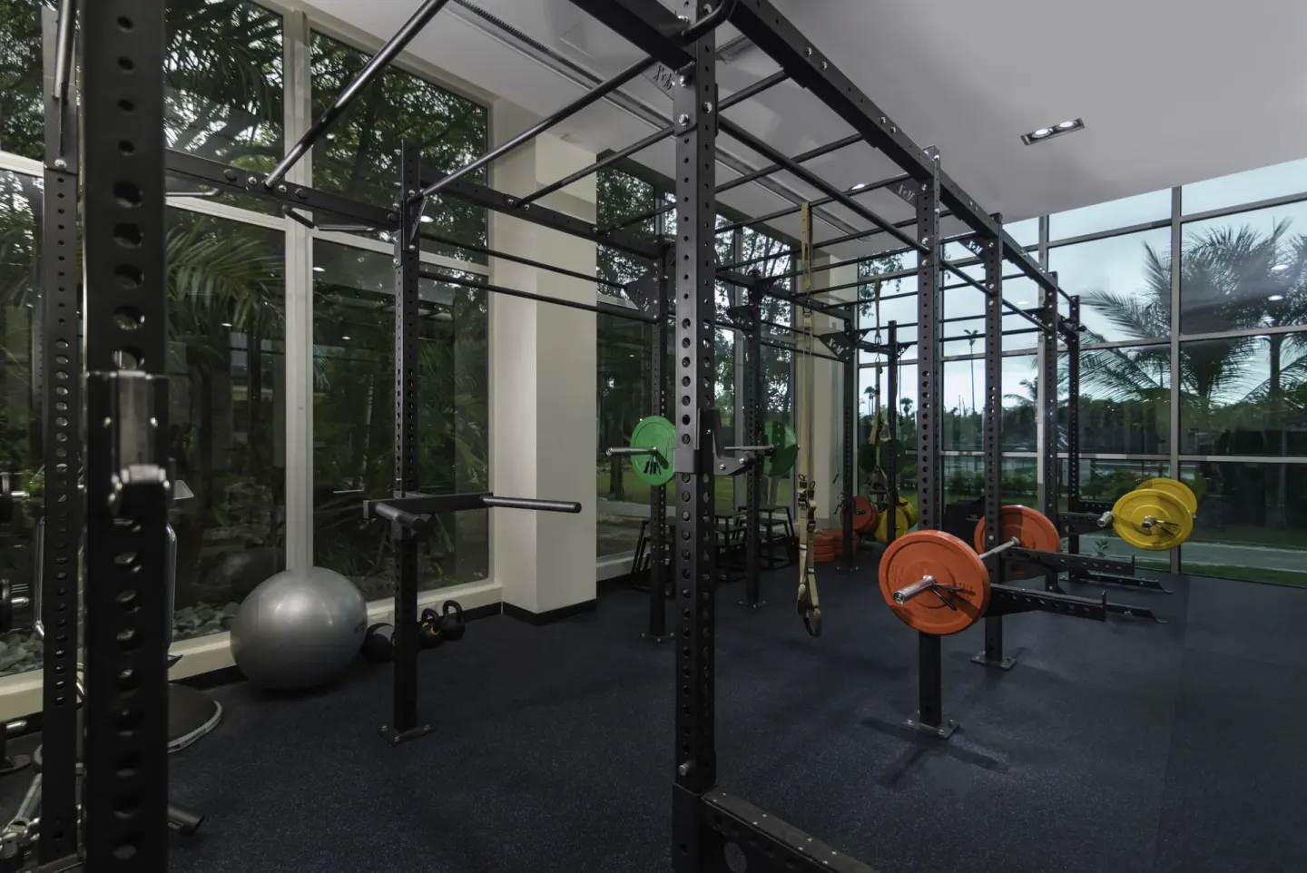 Weight racks, bars and colorful plates in the fitness center at Iberostar Waves Dominicana.