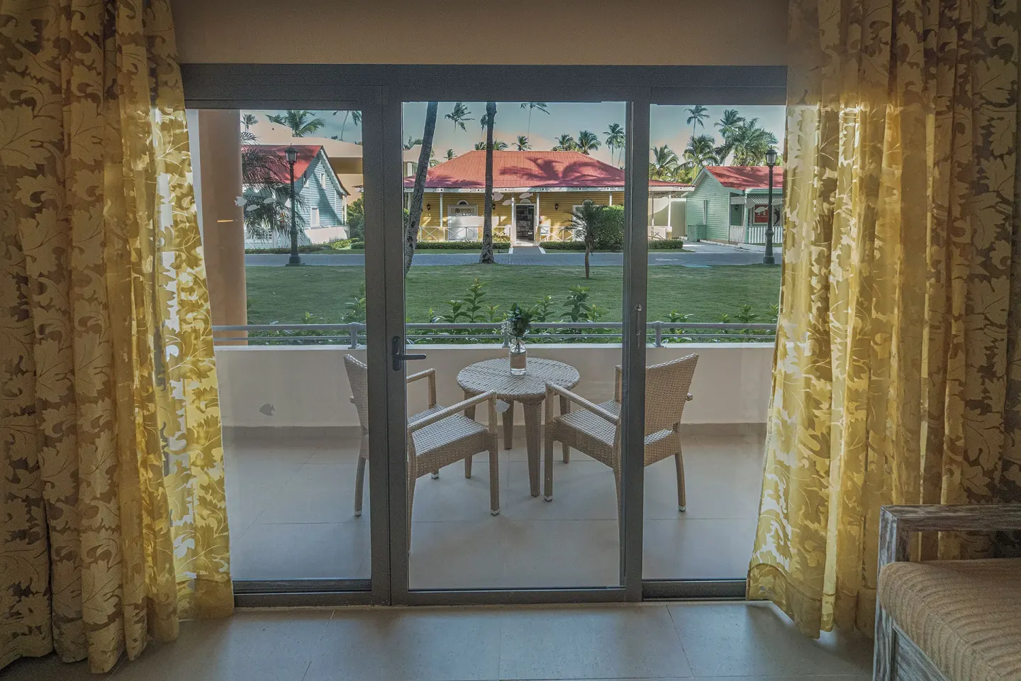 Guest room balcony with two chairs and a round table at Iberostar Waves Dominicana.
