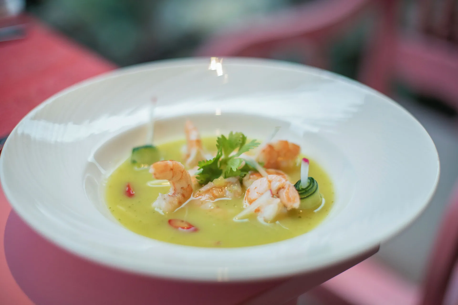 Shrimp in a green chilled soup served in a white bowl at Iberostar Waves Dominicana.