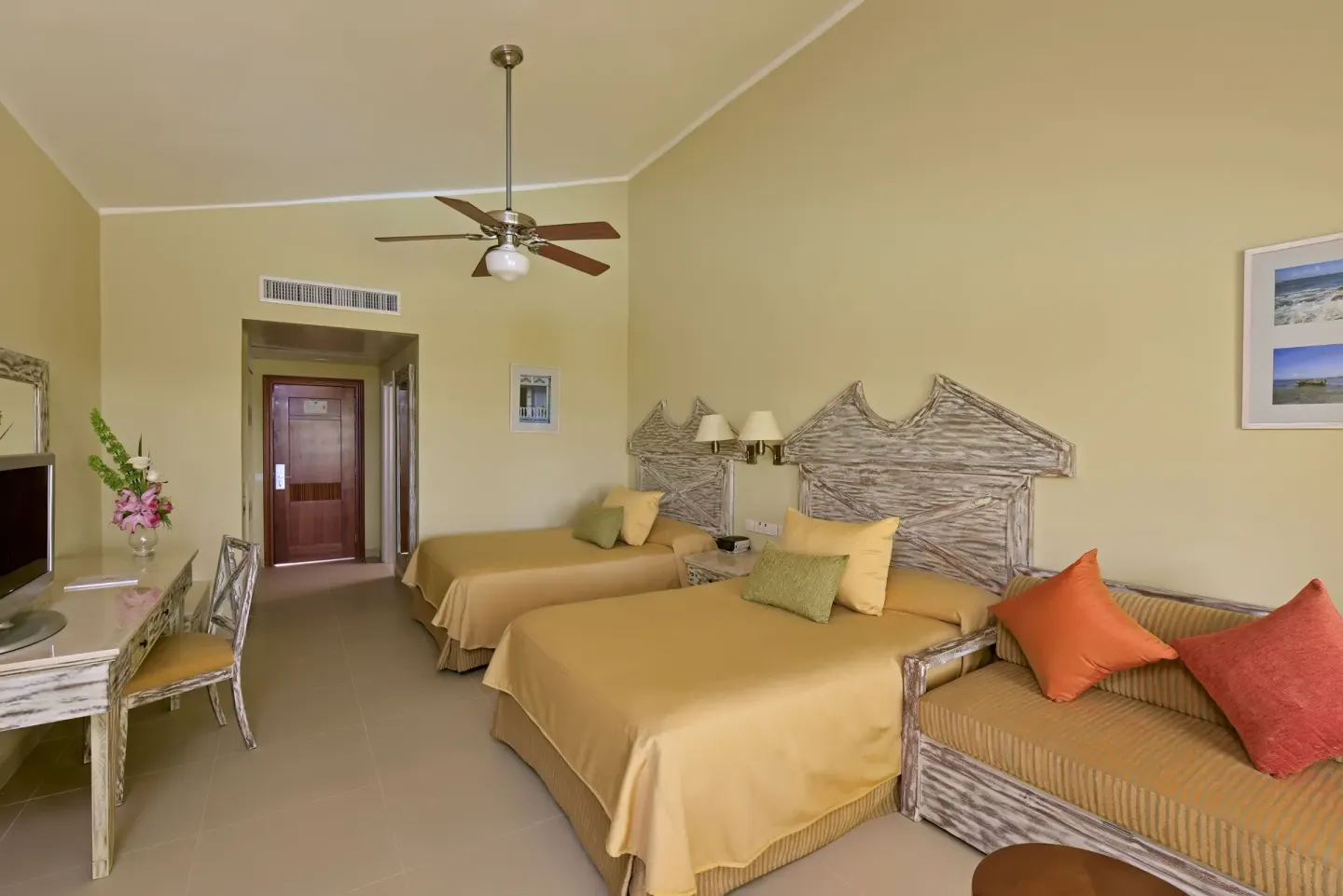 Premium Room Ocean View with two beds, sofa, desk, and TV at Iberostar Waves Dominicana.