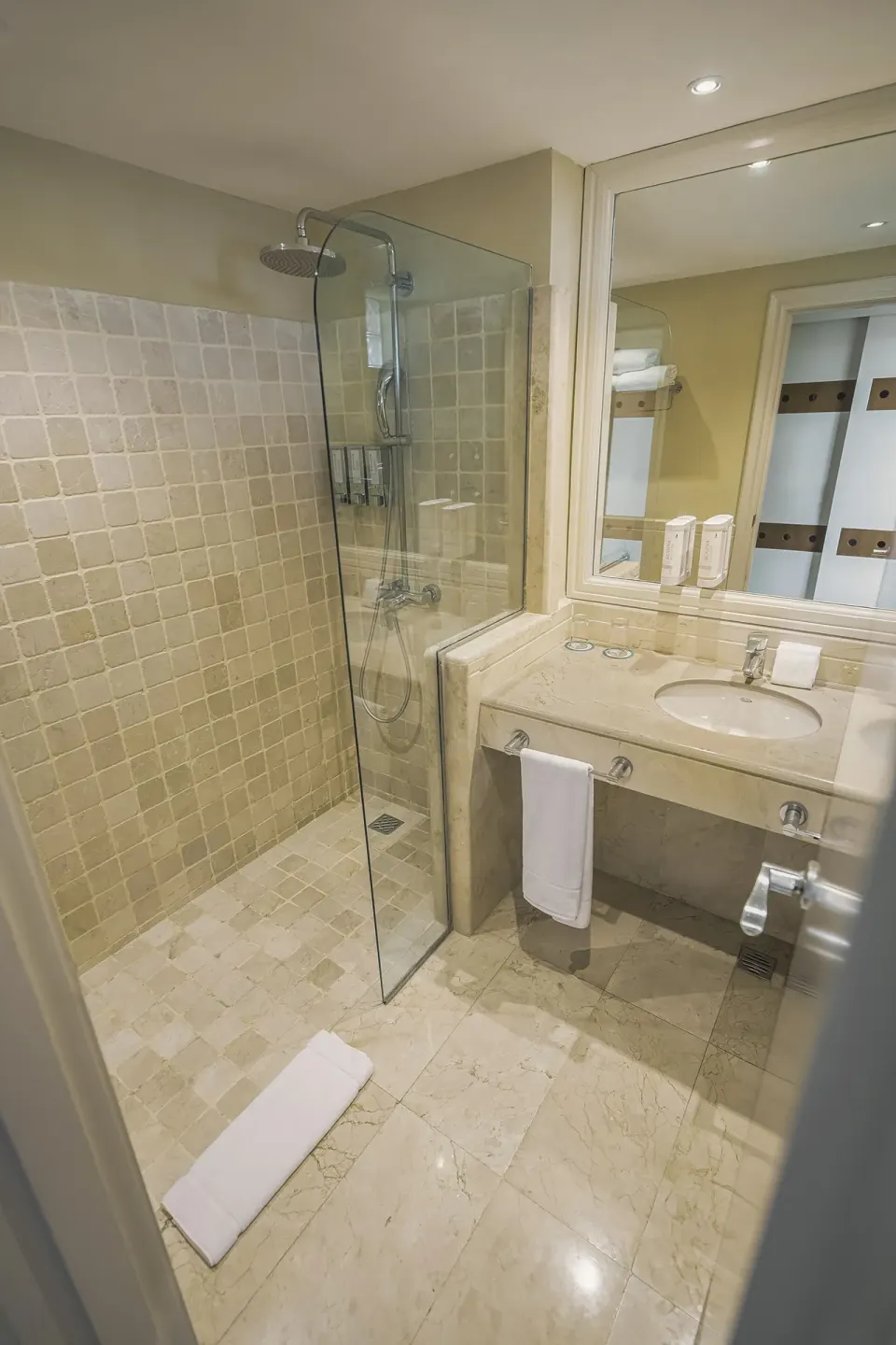 Premium Room Tropical View bathroom with glass shower at Iberostar Waves Dominicana.