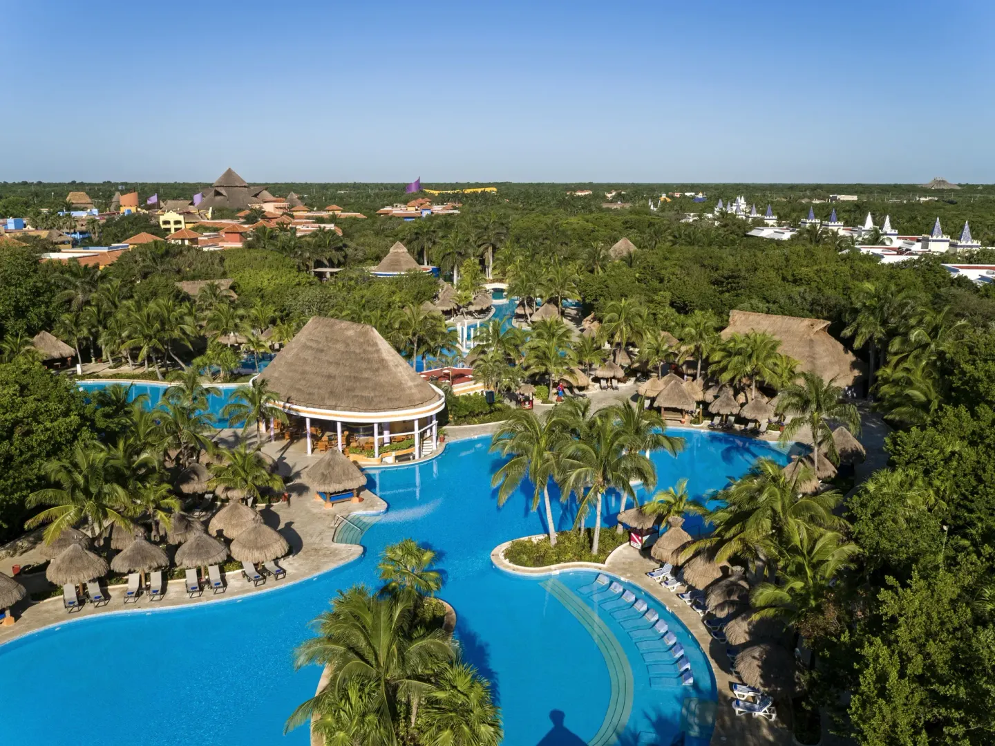 Aerial view of resort pools and palms at Iberostar Waves Paraíso Beach.