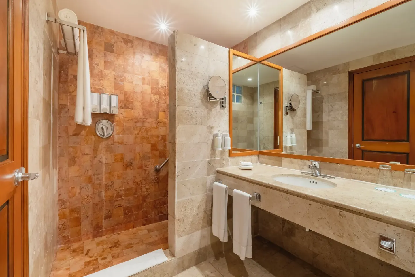Junior Suite Beachside bathroom with shower and vanity at Iberostar Waves Paraíso Beach.