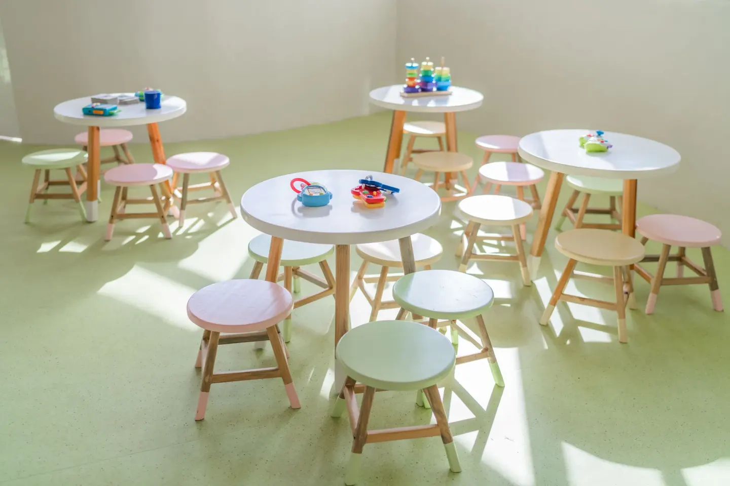 Children’s activity tables with pastel stools and toys at Iberostar Waves Paraíso del Mar.