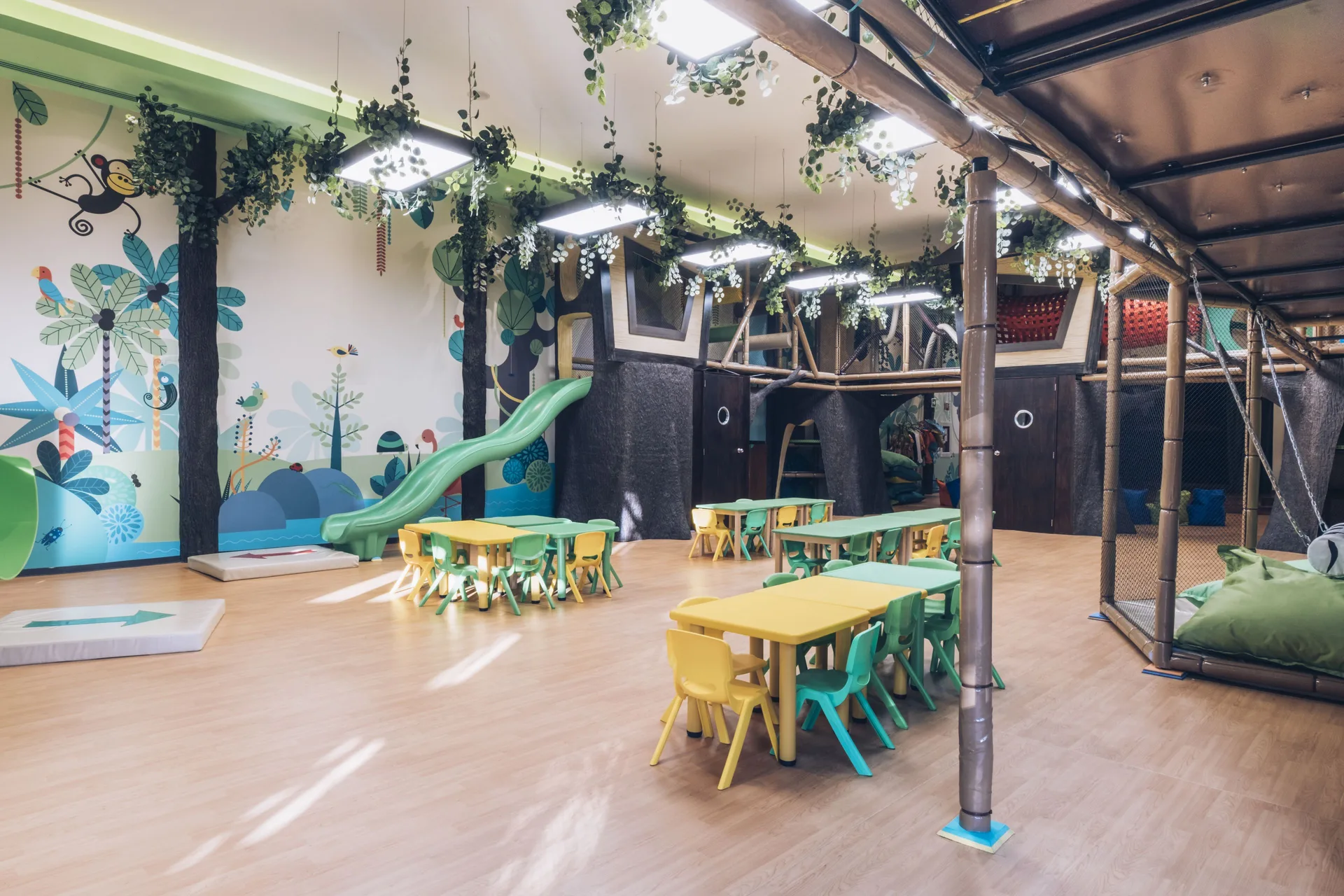 Indoor kids’ playroom with slide and activity tables at Iberostar Waves Paraíso del Mar.