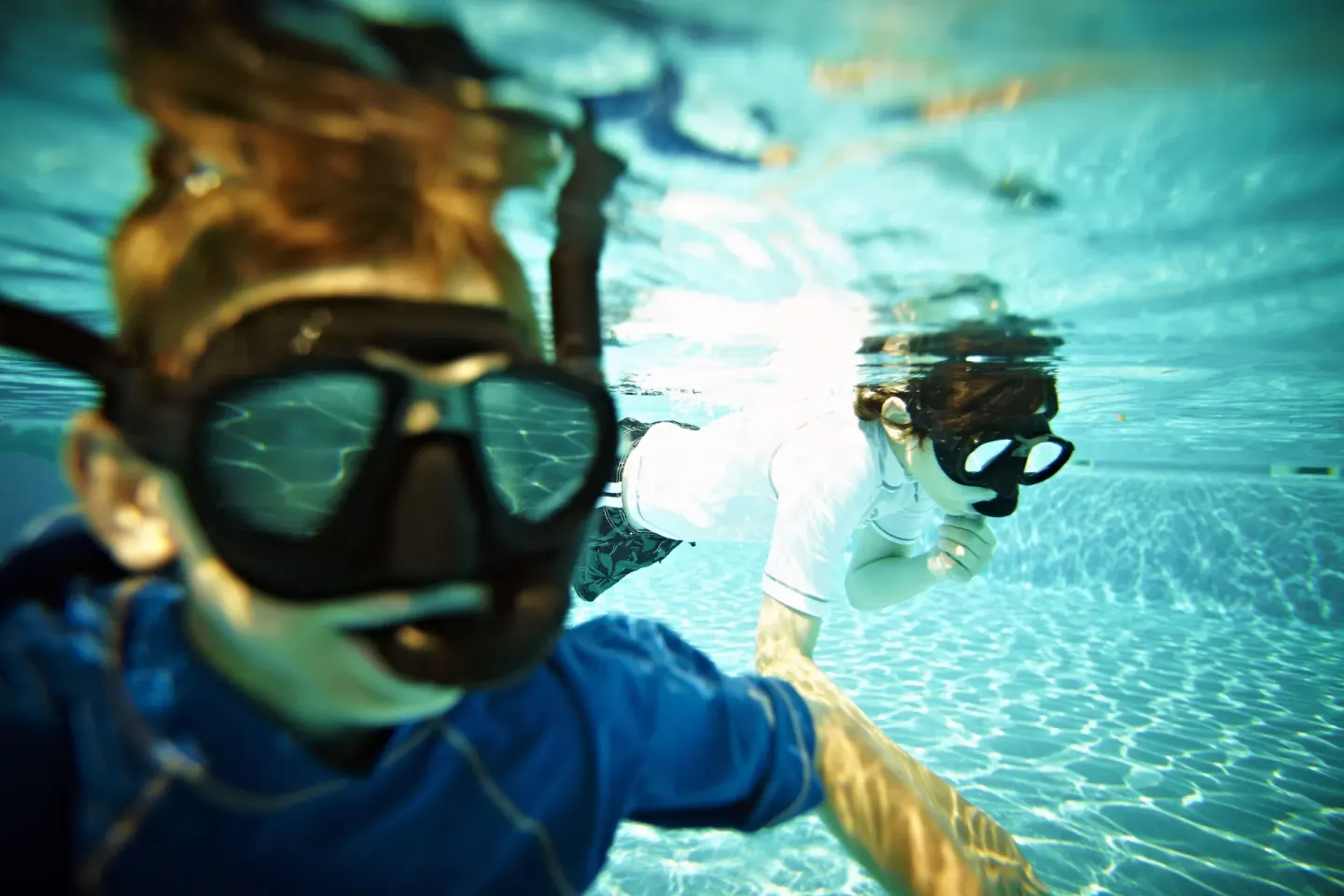 Two people snorkeling underwater in a pool at Iberostar Waves Paraíso del Mar.