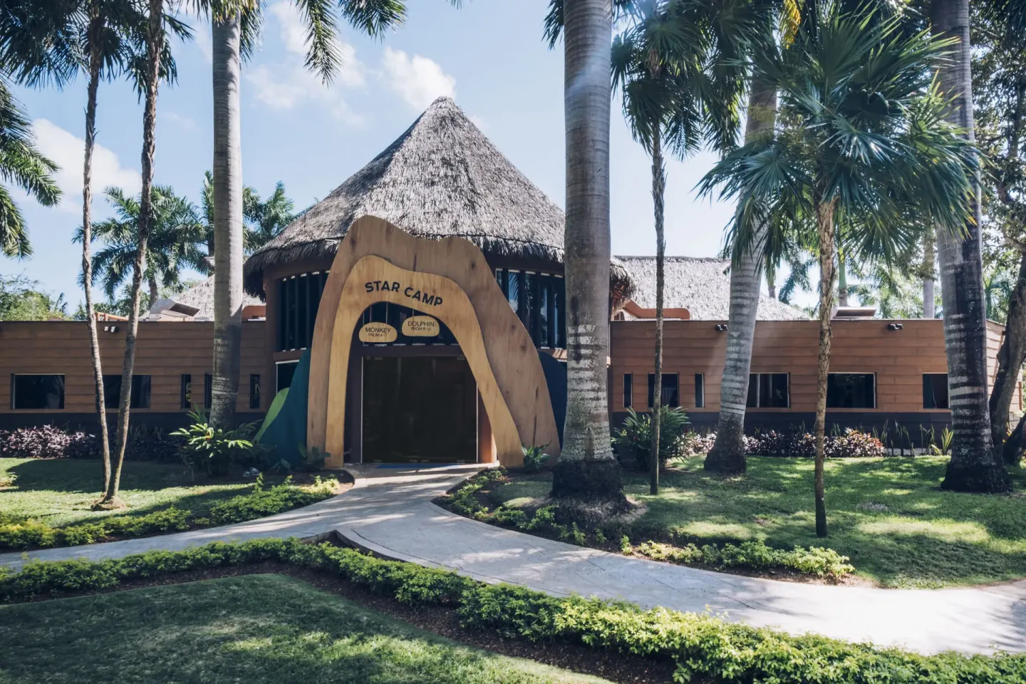 Star Camp building entrance surrounded by palms at Iberostar Waves Paraíso del Mar.