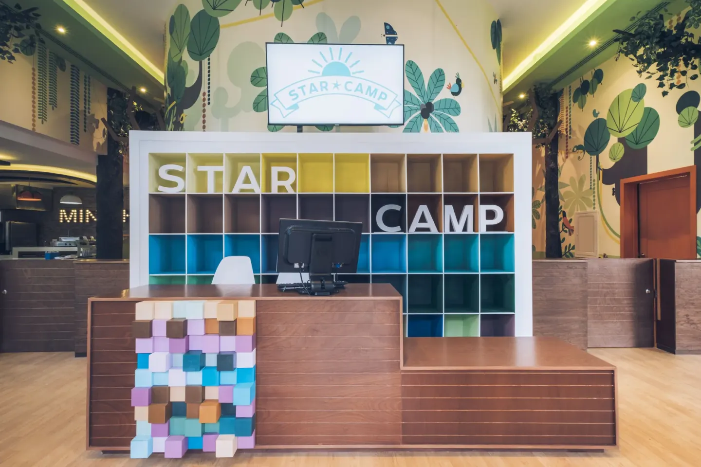Star Camp reception desk with colorful cubbies at Iberostar Waves Paraíso del Mar.