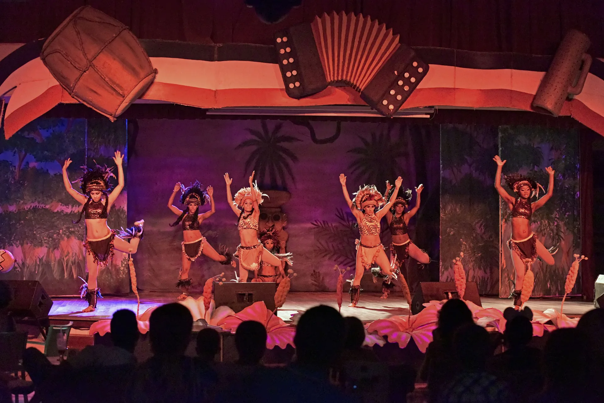 Stage dancers perform in costume before an audience at Iberostar Waves Punta Cana.