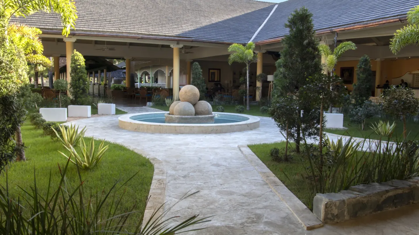 Garden courtyard fountain and covered walkways at Iberostar Waves Punta Cana.