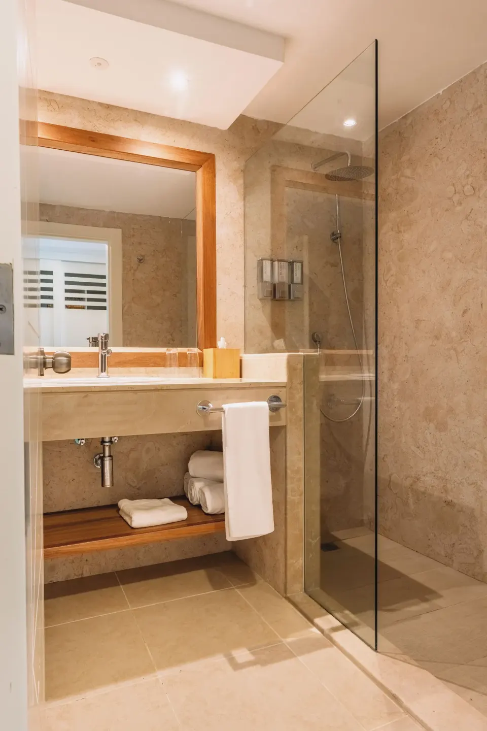 Bathroom vanity and glass shower at Iberostar Waves Punta Cana.