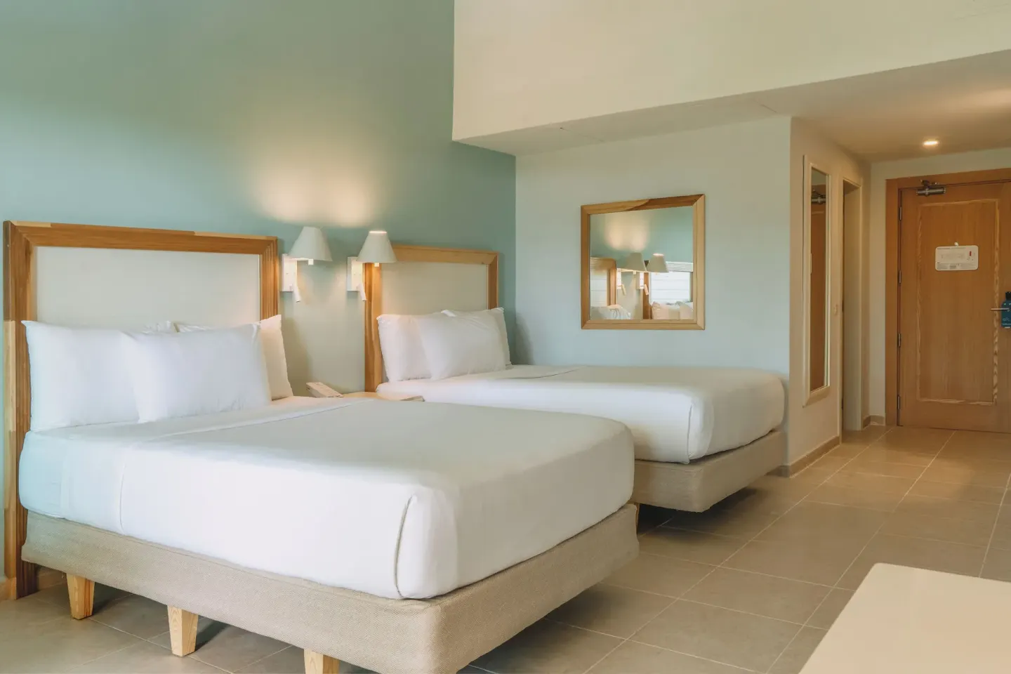 Two double beds near the entry door at Iberostar Waves Punta Cana.