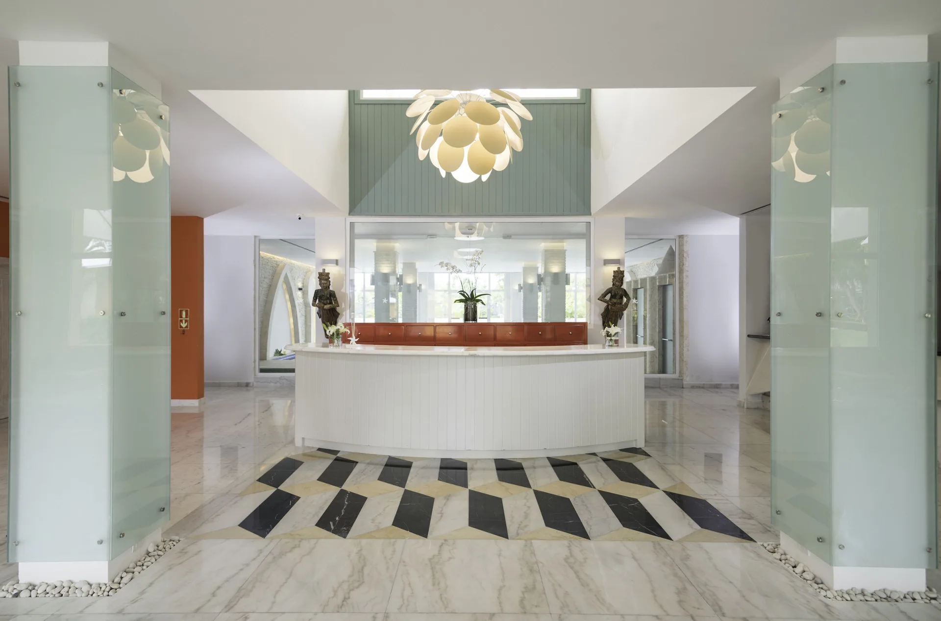 Spa reception desk with sculptural lighting at Iberostar Waves Punta Cana.