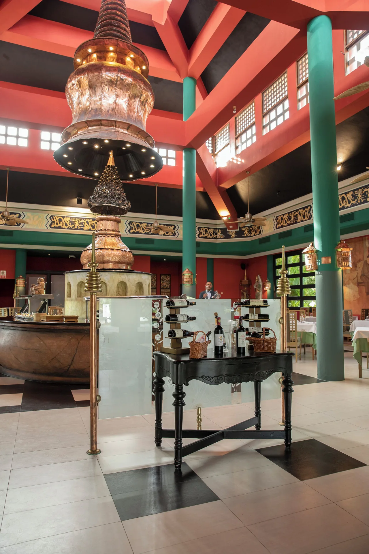 Decorative restaurant entrance with wine display and tall columns at Iberostar Waves Punta Cana.