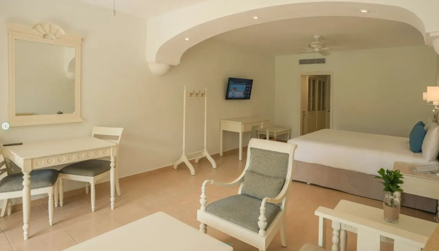 Junior Suite with king bed, desk and mirror at Iberostar Waves Punta Cana.
