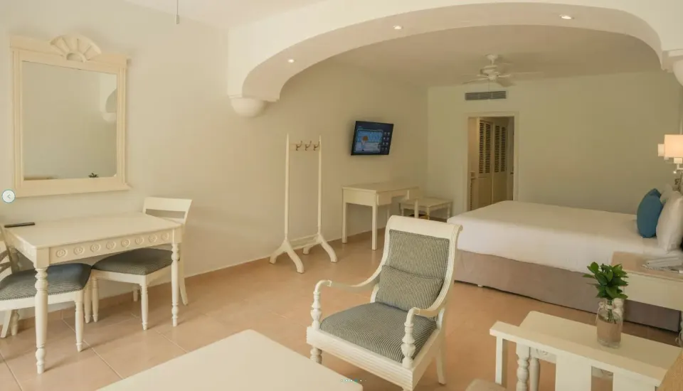 Junior Suite with king bed, desk and mirror at Iberostar Waves Punta Cana.