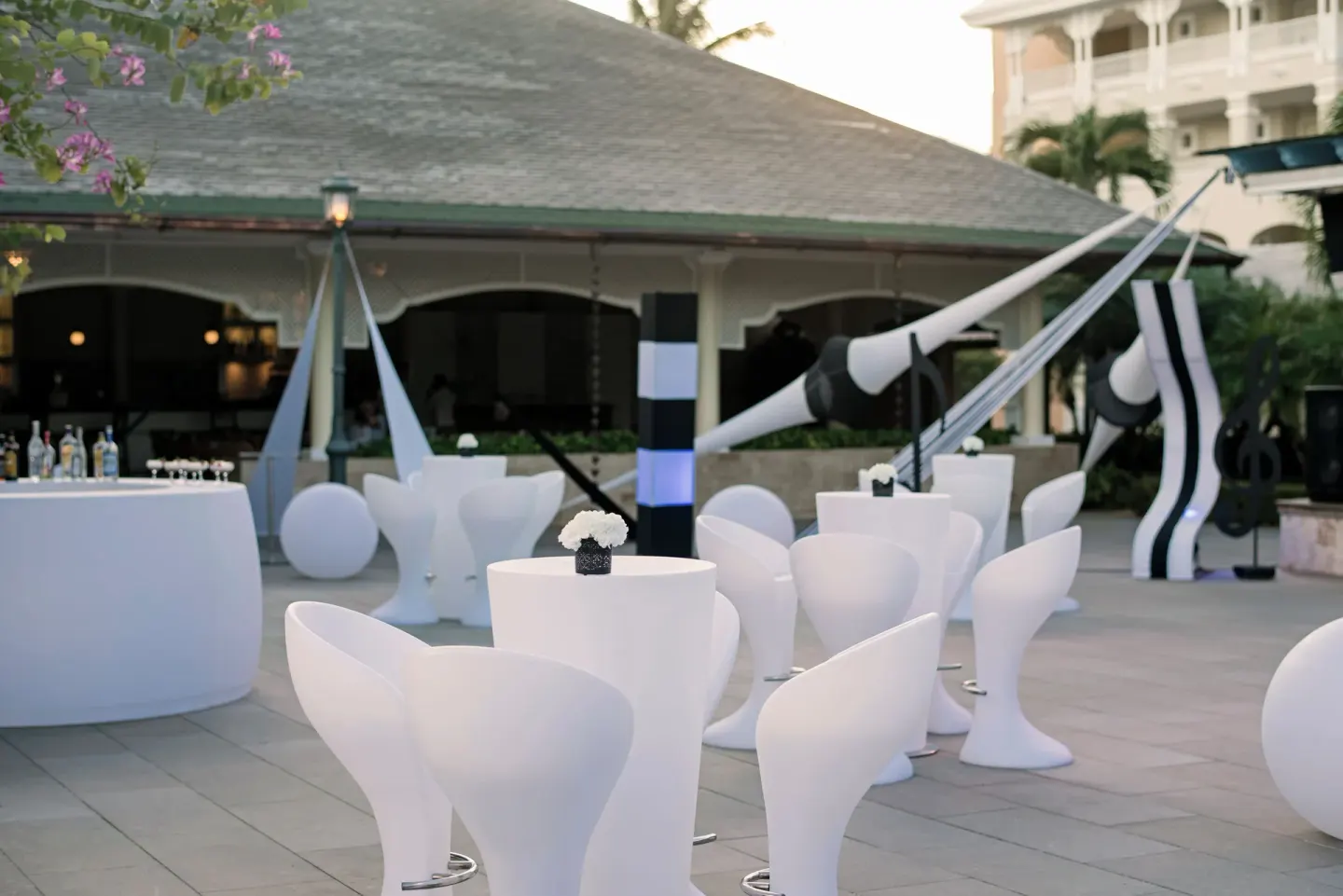 Outdoor event setup with white tables and chairs at Iberostar Waves Punta Cana.