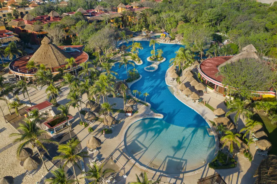 Aerial view of the resort pools, palapas and tropical grounds at Iberostar Waves Tucán