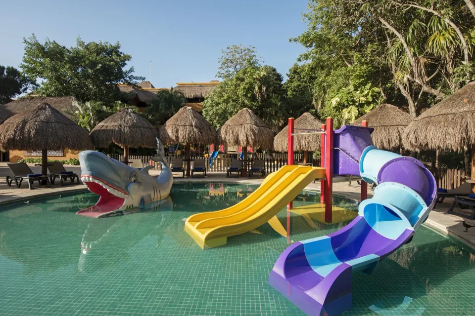 Children's play pool with colorful slides and shark feature at Iberostar Waves Tucán
