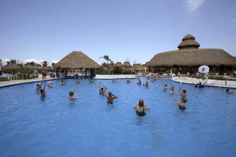 Guests doing water aerobics in the resort pool at Iberostar Waves Tucán