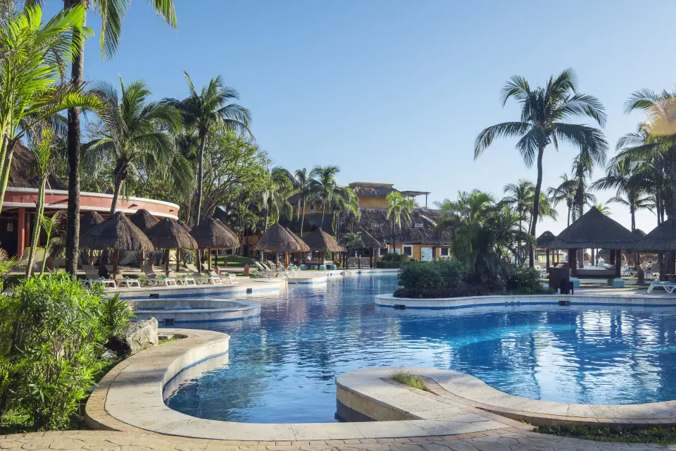 Large main pool with palapas and lounge chairs at Iberostar Waves Tucán