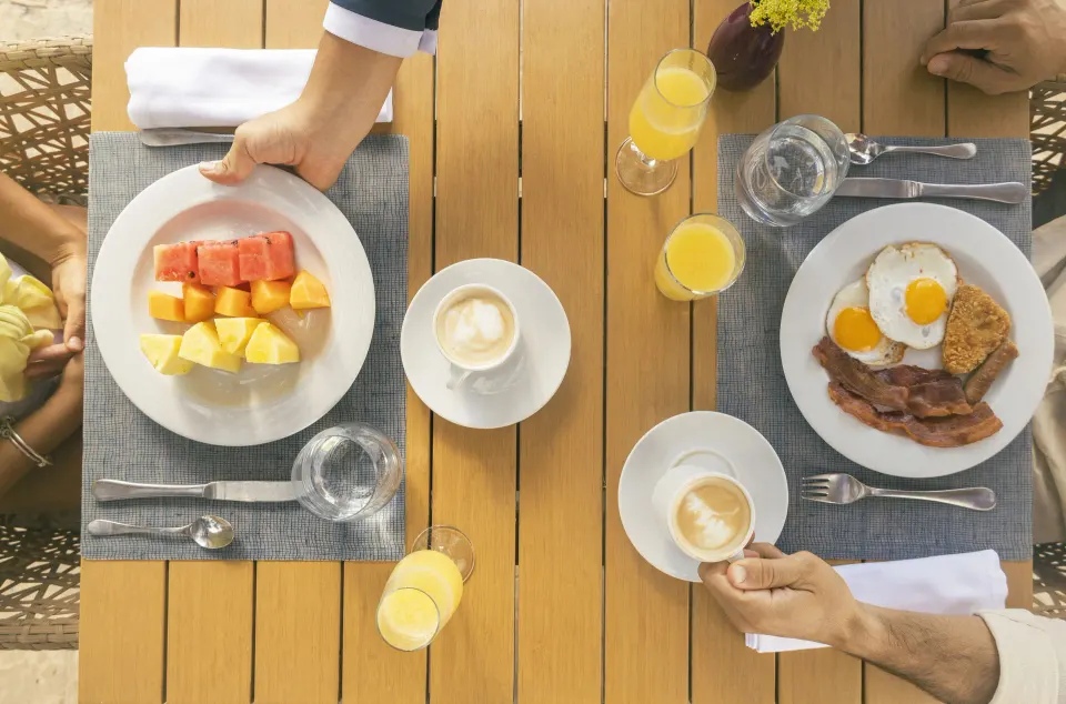 Breakfast table with fruit, eggs and coffee at Iberostar Waves Tucán