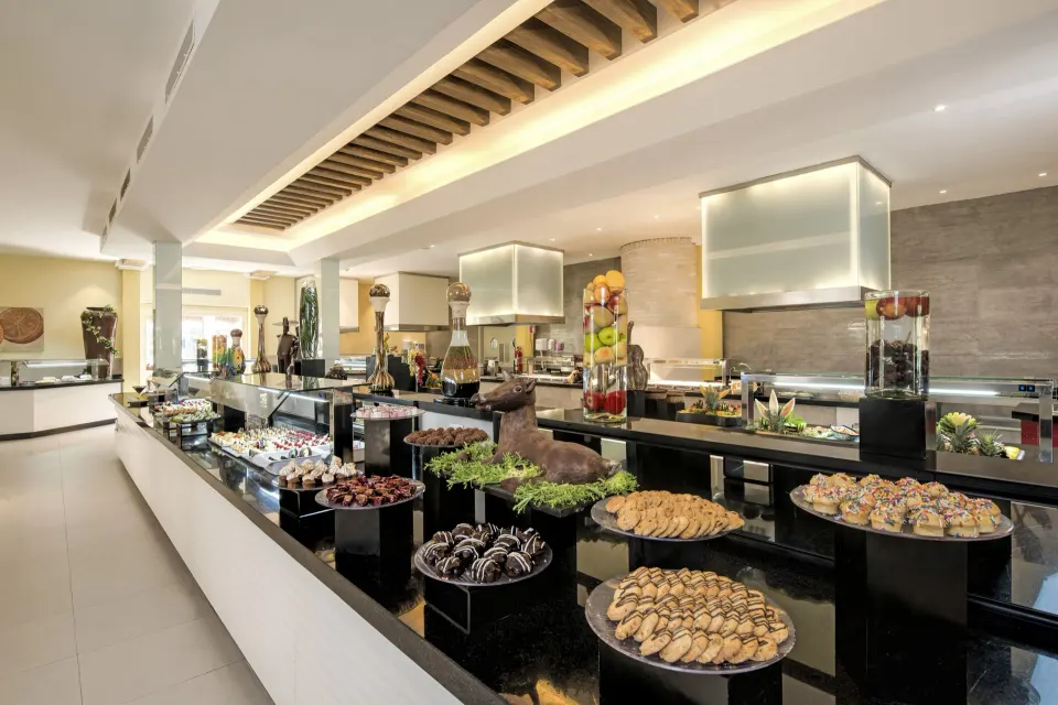 Dessert and pastry display on black pedestals at Iberostar Waves Tucán buffet