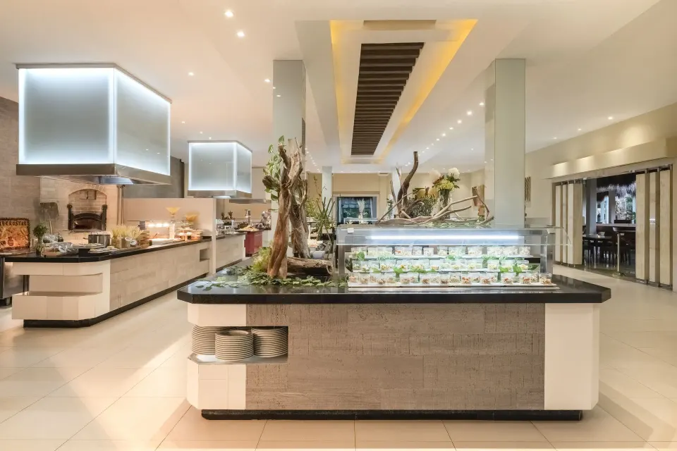 Interior buffet stations in a bright dining room at Iberostar Waves Tucán