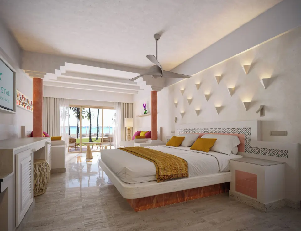 Spacious Junior Suite Oceanfront king bed and balcony view of beach at Iberostar Waves Tucán
