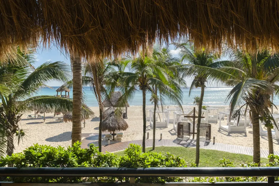 Balcony of a Junior Suite Oceanfront at Iberostar Waves Tucán overlooking beach loungers and the sea.