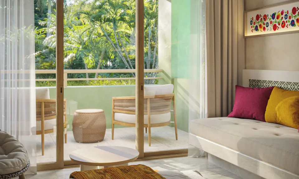 Private balcony seating and tropical view from a Premium Room at Iberostar Waves Tucán
