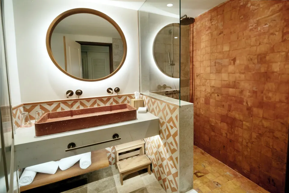 Premium Room bathroom with sculpted sink and walk-in shower at Iberostar Waves Tucán