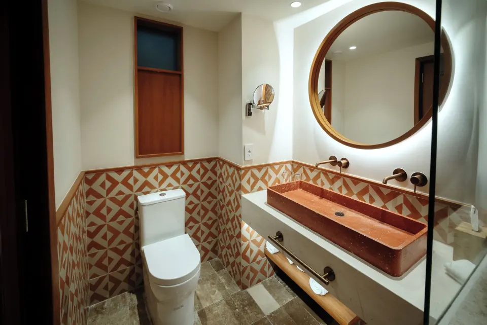 Premium Room bathroom vanity, mirror and toilet at Iberostar Waves Tucán