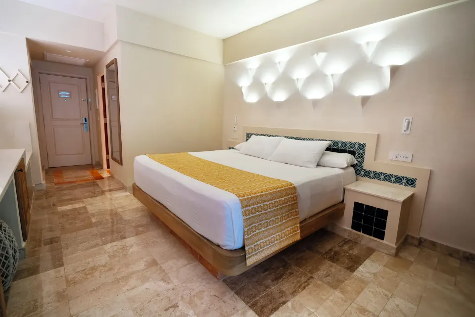 Premium Room with a king bed and minimalist decor at Iberostar Waves Tucán