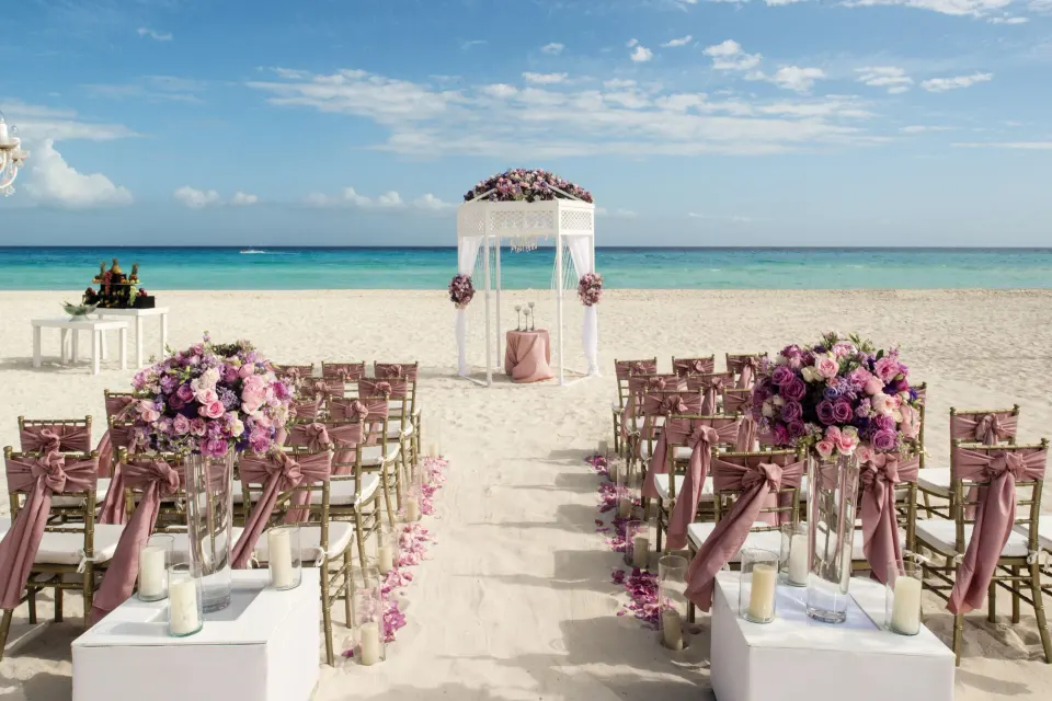 Beach wedding arch and chairs set up on the sand at Iberostar Waves Tucán.
