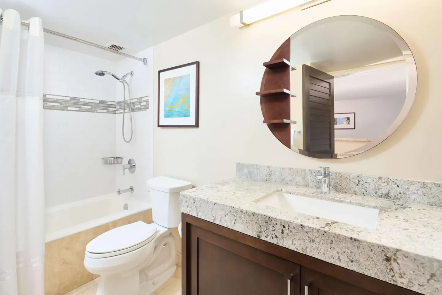 Bathroom with tub-shower and stone vanity at Ilikai Hotel.