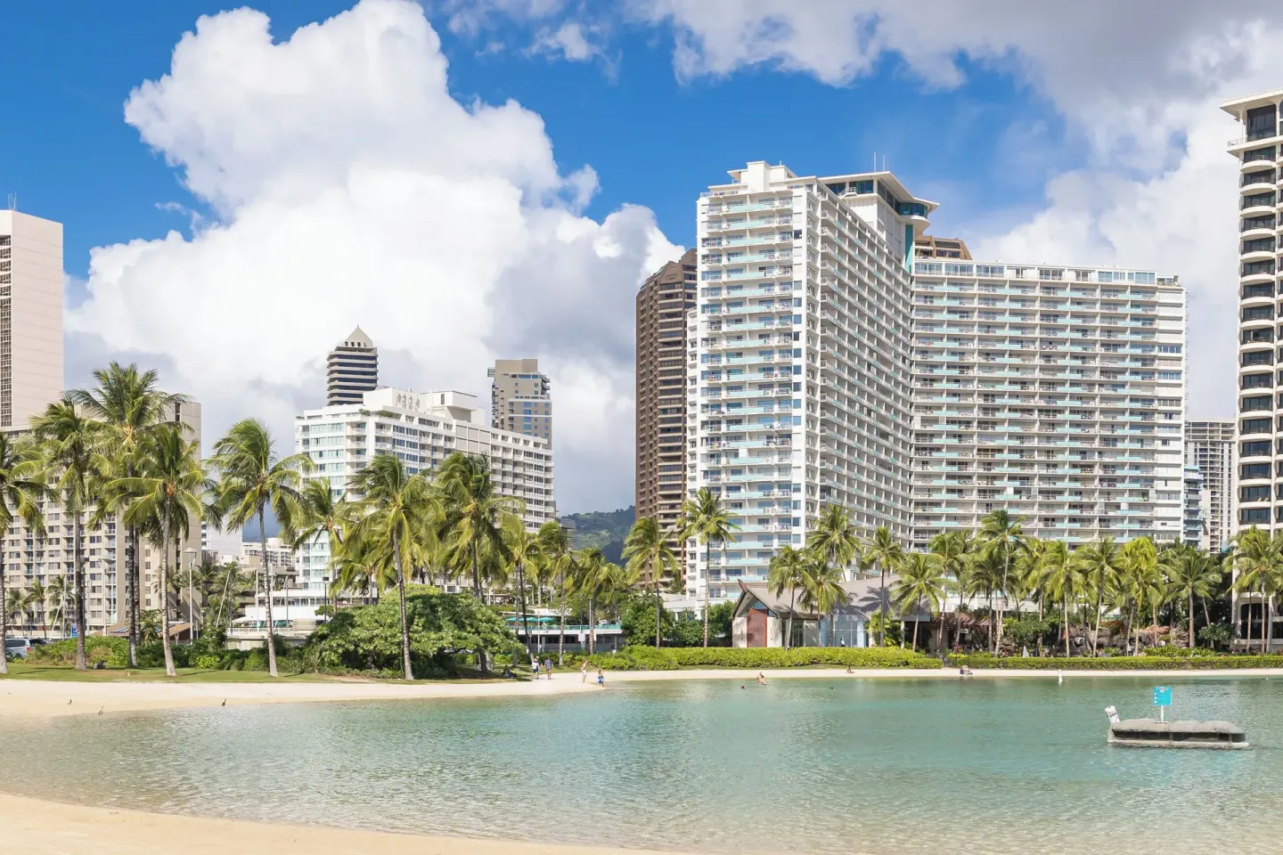 Lagoon, palm trees, and high-rise hotel exterior at Ilikai Hotel.